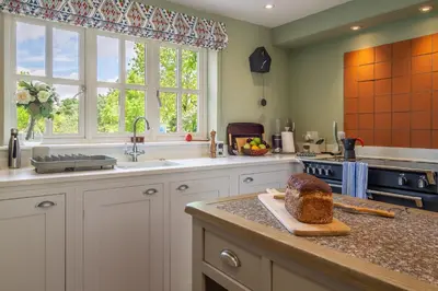a kitchen with a loaf of bread on a counter at Foxhole Cottage 10 in Stowmarket
