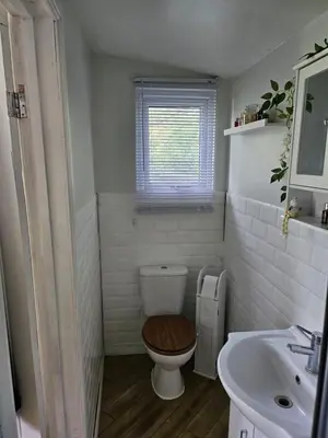 a bathroom with a toilet and a sink at Dunmow 1-Bed Cabin Sleeps 4 10 mins to Stansted in Great Dunmow