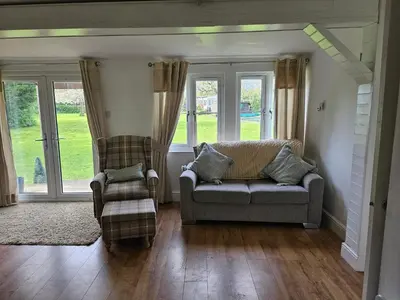 a living room with a couch and two chairs at Dunmow 1-Bed Cabin Sleeps 4 10 mins to Stansted in Great Dunmow