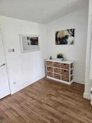 an empty living room with a dog on the wall at Dunmow 1-Bed Cabin Sleeps 4 10 mins to Stansted in Great Dunmow