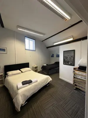 a bedroom with a large bed in a room at The Stables in Takeley