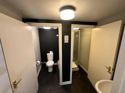 a small bathroom with a toilet and a sink at The Stables in Takeley