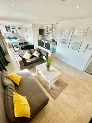 a living room with a couch and a table at Studio - Sleeps 2 - Parking - Wifi in Cambridge