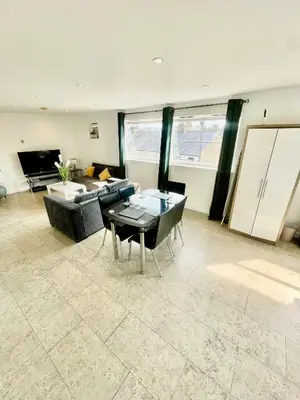 a living room with a couch and a table at Studio - Sleeps 2 - Parking - Wifi in Cambridge