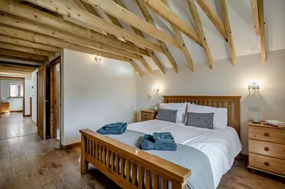 a bedroom with a bed with two towels on it at 4 Bed in Barnham Broom oc-b27788 in Kimberley