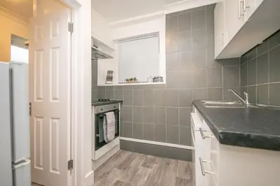 a kitchen with a sink and a counter top at Beautiful Ground Floor Victorian Apartment in Clacton-on-Sea