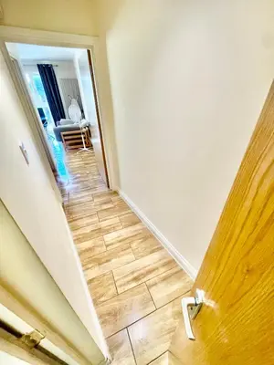 a hallway leading to a room with a wooden floor at cambridge city centre immaculate Studio sleeps 2 - central location paradise street in Cambridge