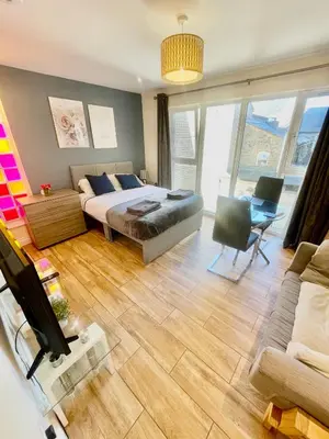 a living room with a bed and a couch at cambridge city centre immaculate Studio sleeps 2 - central location paradise street in Cambridge
