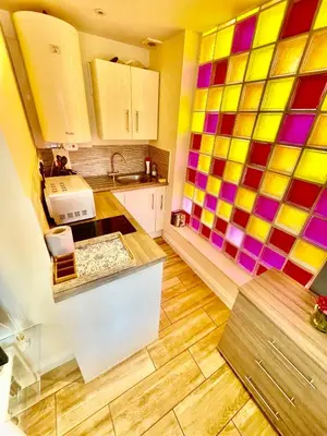 a kitchen with colorful tiles on the walls at cambridge city centre immaculate Studio sleeps 2 - central location paradise street in Cambridge