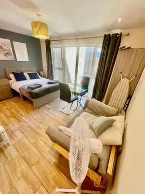 a bedroom with a bed and a living room at cambridge city centre immaculate Studio sleeps 2 - central location paradise street in Cambridge