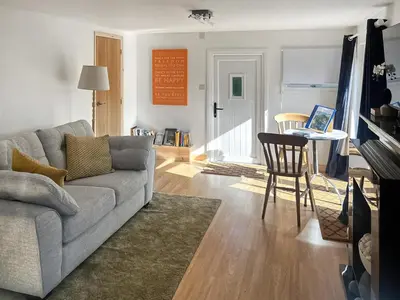 a living room with a couch and a table with a laptop at Island Lodge - Uk46767 in Little Baddow