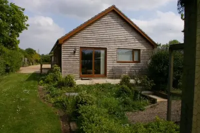 a small house with a window in a yard at 2 Bed in Attleborough oc-1277 in Old Buckenham