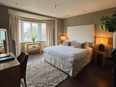 a bedroom with a large white bed and a desk and a desk at Mulberry Tree in Attleborough