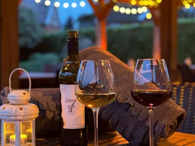 two glasses of wine sitting on a wooden table at Mulberry Tree in Attleborough