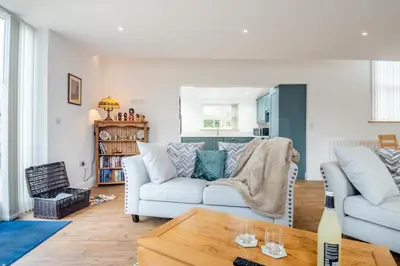 a living room with a white couch and a table at 1 Bed in Tasburgh oc-t28242 in Ashwellthorpe