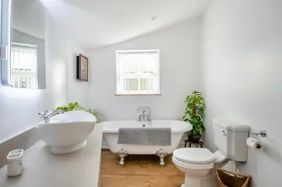 a bathroom with a tub and a toilet and a sink at 1 Bed in Tasburgh oc-t28242 in Ashwellthorpe