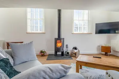 a living room with a couch and a fire place at 1 Bed in Tasburgh oc-t28242 in Ashwellthorpe