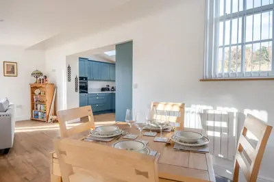 a kitchen and dining room with a table and chairs at 1 Bed in Tasburgh oc-t28242 in Ashwellthorpe