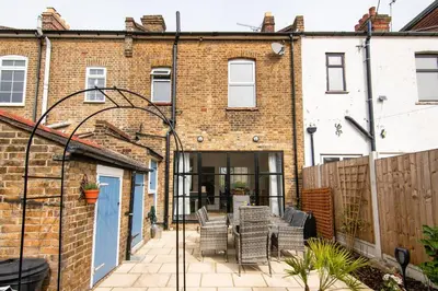 a patio in front of a brick building at Cosy Stylish house near Southend - Pass the Keys in Southend-on-Sea