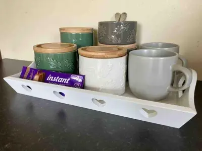 a shelf with cups and other items on it at Entire studio with private parking and balcony in Southend-on-Sea