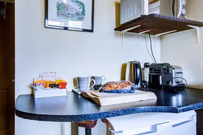 a counter top with a coffee maker on it at Entire studio with private parking and balcony in Southend-on-Sea