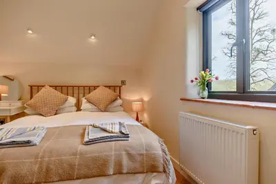 a bedroom with a bed and a window at 2 Bed in Ketteringham oc-p27381 in East Carleton