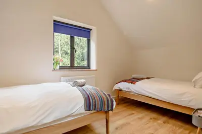 two beds in a room with a window at 2 Bed in Ketteringham oc-p27381 in East Carleton