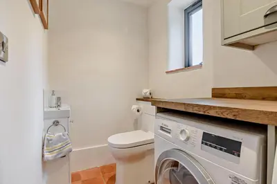 a bathroom with a toilet and a washing machine at 2 Bed in Ketteringham oc-p27381 in East Carleton