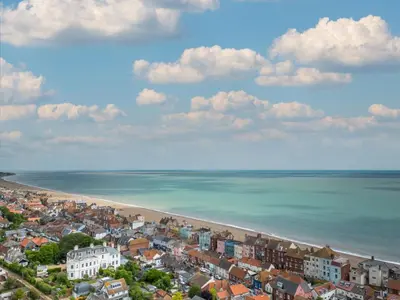 an aerial view of a beach with houses and the ocean at 1 Bed in Aldeburgh oc-h28976 in Aldeburgh