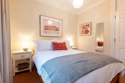 a bedroom with a bed with a red pillow at 1 Bed in Aldeburgh oc-h28976 in Aldeburgh