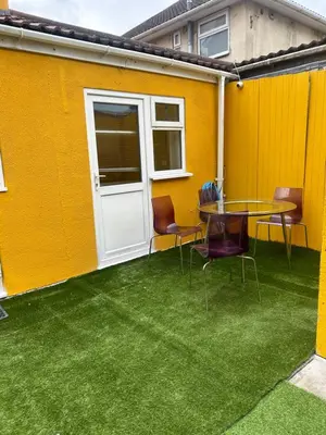 a patio with a table and chairs in front of a building at Welcoming Guesthouse in Cambridge