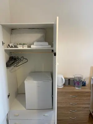 a closet with a washer and dryer in it at Welcoming Guesthouse in Cambridge