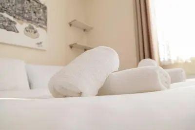 a stuffed towel animal sitting on top of a bed at Pass the Keys 53 Austin Drive · Modern Townhouse near Addenbrookes Own Parking in Cambridge