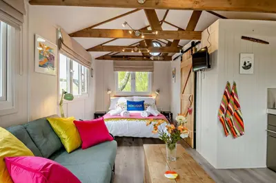 a living room with a couch and a bed at 1 Bed in Chelmondiston oc-l29137 in Chelmondiston