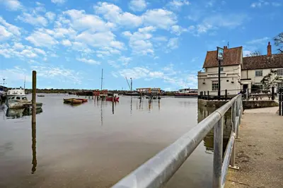 a body of water with a building and boats in it at 1 Bed in Chelmondiston oc-l29137 in Chelmondiston