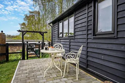 a patio with two chairs and a table on a patio at 1 Bed in Chelmondiston oc-l29137 in Chelmondiston