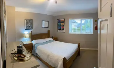 a bedroom with a bed and a table and a window at relaxed and peaceful in St Ives