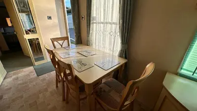 a dining room table with four chairs and a window at Getaway House in Clacton-on-Sea