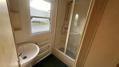 a small bathroom with a sink and a shower at Getaway House in Clacton-on-Sea