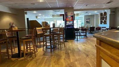 a restaurant with a bar and some chairs and tables at Getaway House in Clacton-on-Sea