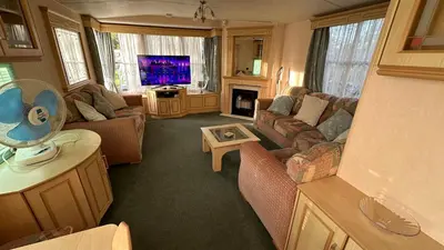 a living room with a couch and a tv at Getaway House in Clacton-on-Sea