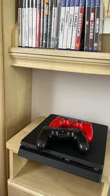 a video game controller sitting on top of a book shelf at Caravan home Clacton-On-Sea St Osyth in Saint Osyth