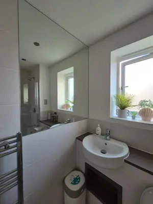 a white bathroom with a sink and a mirror at Double Room in a shared 4 bedroom family home in Broomfield in Chelmsford
