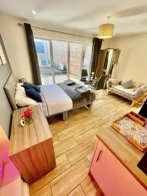 a bedroom with a bed and a living room at 1 Bed Studio - Sleeps 2 - Parking - Wifi in Cambridge