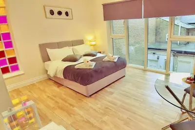 a bedroom with a bed with two towels on it at 1 Bed Studio - Sleeps 2 - Parking - Wifi in Cambridge