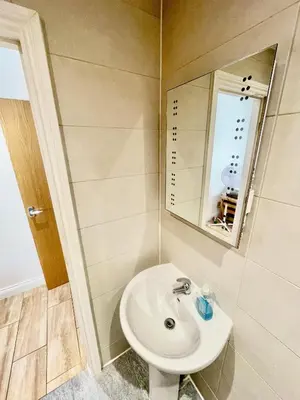 a bathroom with a sink and a mirror at 1 Bed Studio - Sleeps 2 - Parking - Wifi in Cambridge