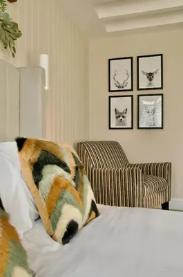 a bedroom with a bed with a pillow and a chair at The Sunset Nook in Ipswich