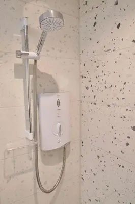 a shower in a bathroom with a shower head at The Sunset Nook in Ipswich