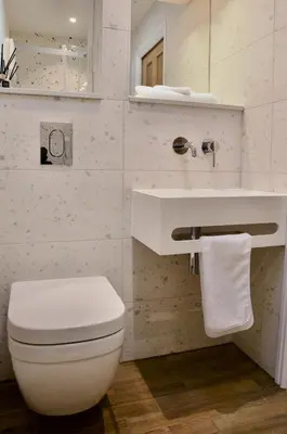 a white bathroom with a toilet and a sink at The Sunset Nook in Ipswich