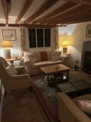 a living room with a couch and a table at Rose Cottage Darsham - Suffolk Coastal in Darsham